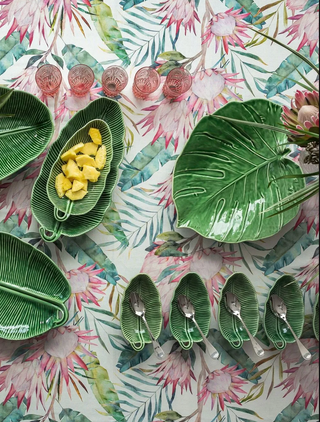 Bordallo Green ceramic plates and bowls on a floral-patterned background