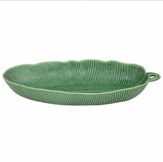 Green ceramic serving dish with textured surface on a white background