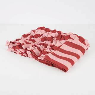 Stack of pink and red striped fabric napkins on a white background