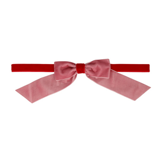 Pink bow with a red ribbon on a white background