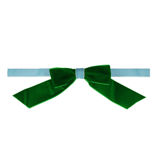 Green bow tie on a light blue headband against a white background