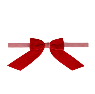 Red velvet bow on a white background