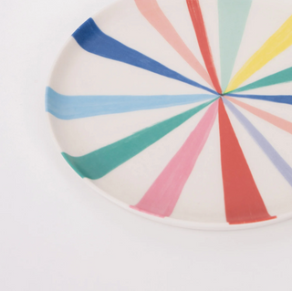 Colorful circular design with radial stripes on a white background