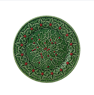 Decorative green plate with holly design on a white background