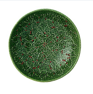 Green ceramic plate with holly leaf pattern on a white background