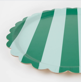 Green and white striped round tray on a white background