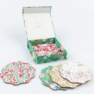 Set of floral coasters with a matching box on a white background