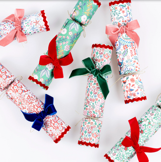 Decorative crackers with floral patterns and colorful bows on a white background