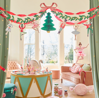 Decorated living room with Christmas-themed decorations and a festive table setting.